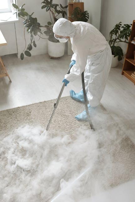 A person kneeling on a patterned carpet in a residential room, wearing casual clothing, operating a yellow canister vacuum cleaner with a black hose. The vacuum cleaner's lid is open, revealing white cloths or filters inside. The carpet is clean, and the room has warm lighting, highlighting the surface cleaning process. This image illustrates the importance of thorough domestic cleaning provided by Greenwich Carpet Cleaners, emphasizing deep carpet maintenance and sanitisation. The scene reflects professional care aimed at maintaining hygiene and freshness in the home, aligning with the services highlighted in 'Avoid hidden charges in carpet cleaning Greenwich Council, Greenwich.'